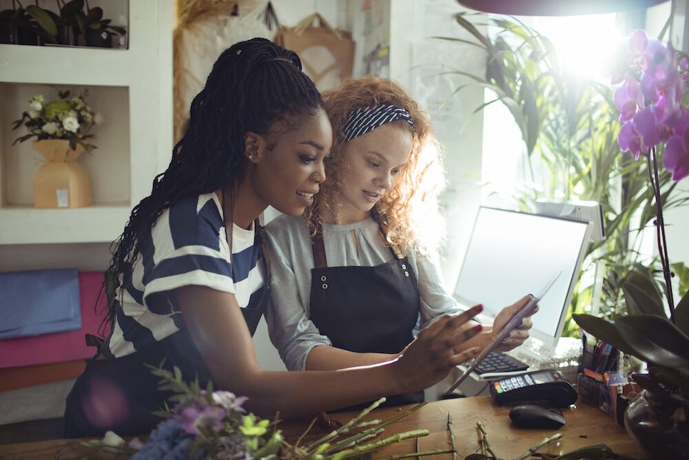 Two female small business owners reviewing business formation options