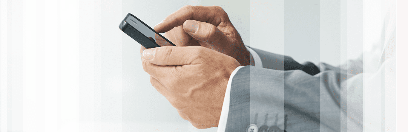 Businessman typing on his smartphone