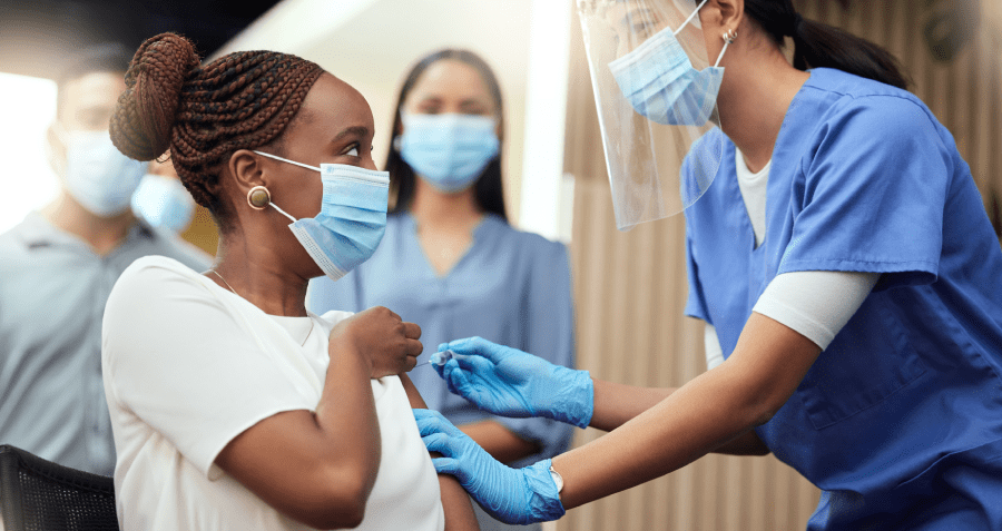 Women getting vaccine shot in her arm