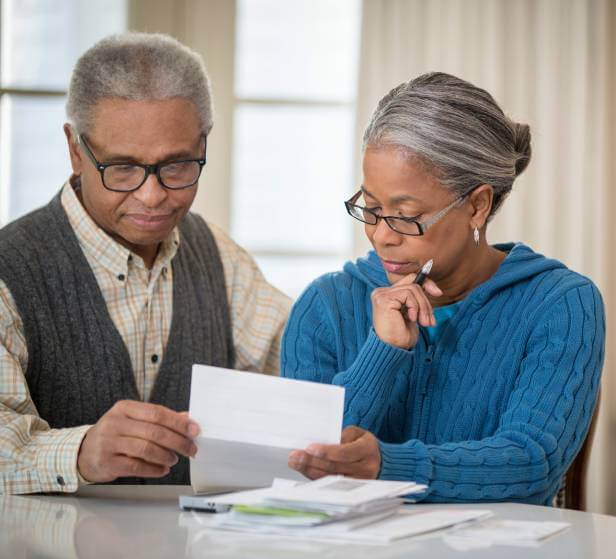 Mature couple look at a mortgage lien legal document.