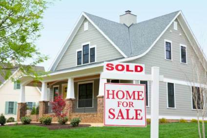 Home with Sold Home for Sale sign in front yard.