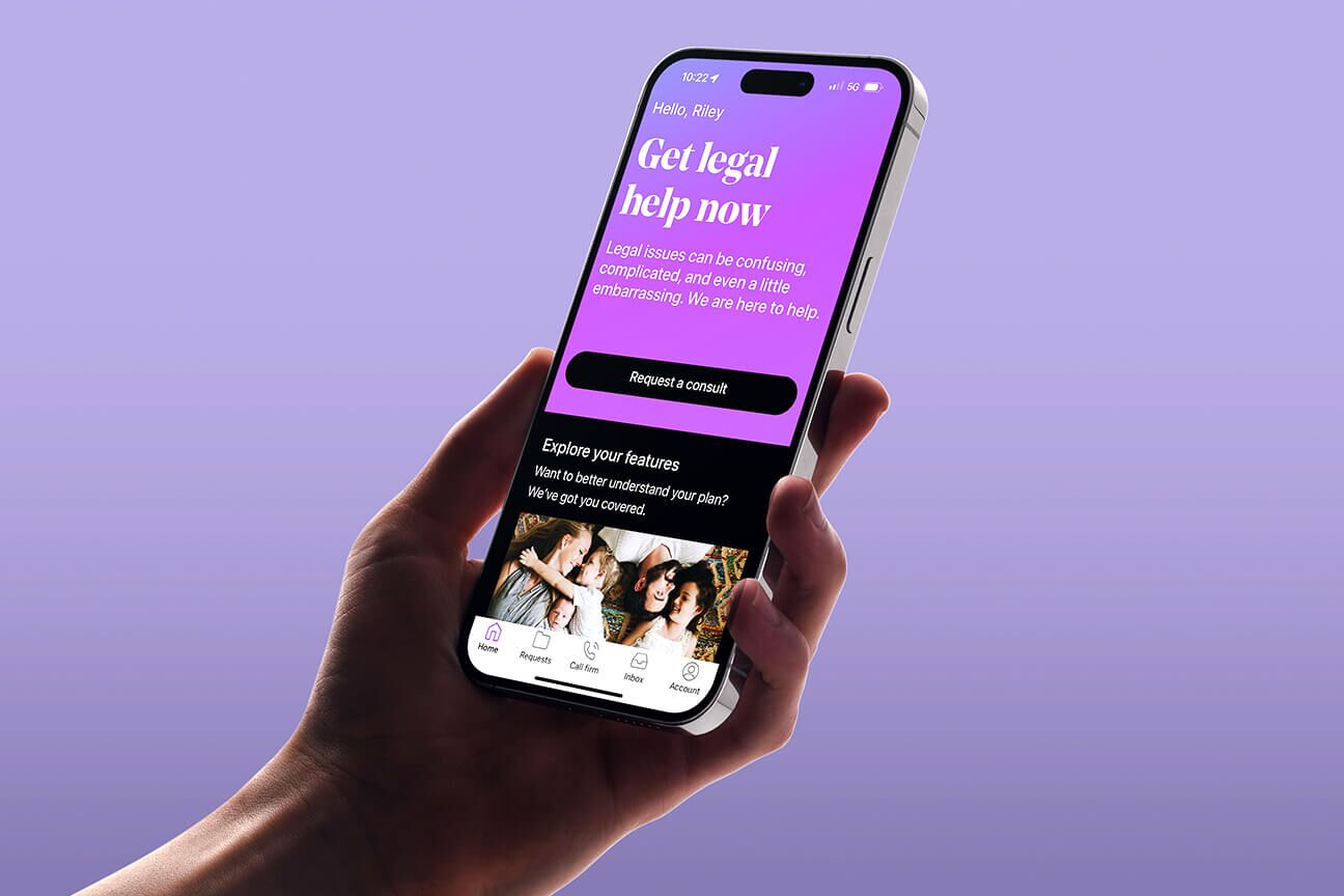 Hand holding their mobile device while looking at the LegalShield app