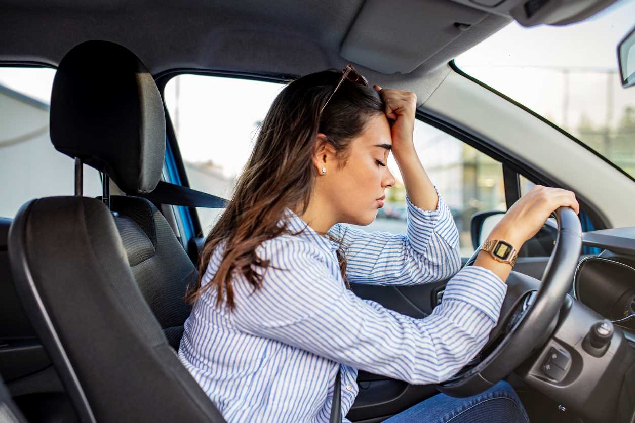 Driver looking distraught after receiving a traffic ticket