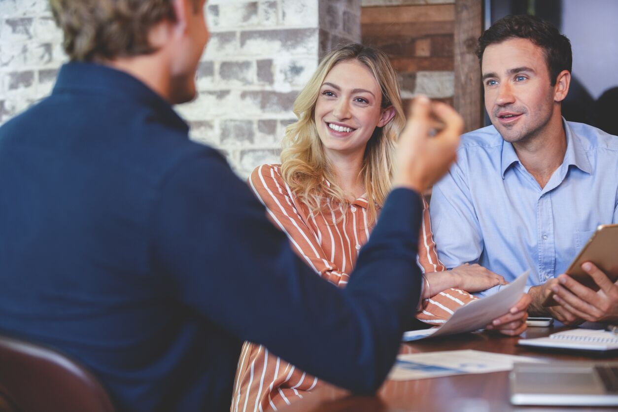 Young couple talking to a healthcare agent