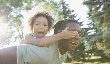 Father playing with adopted daughter