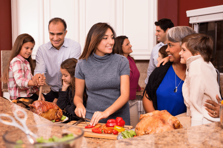 Family gathering together while cooking