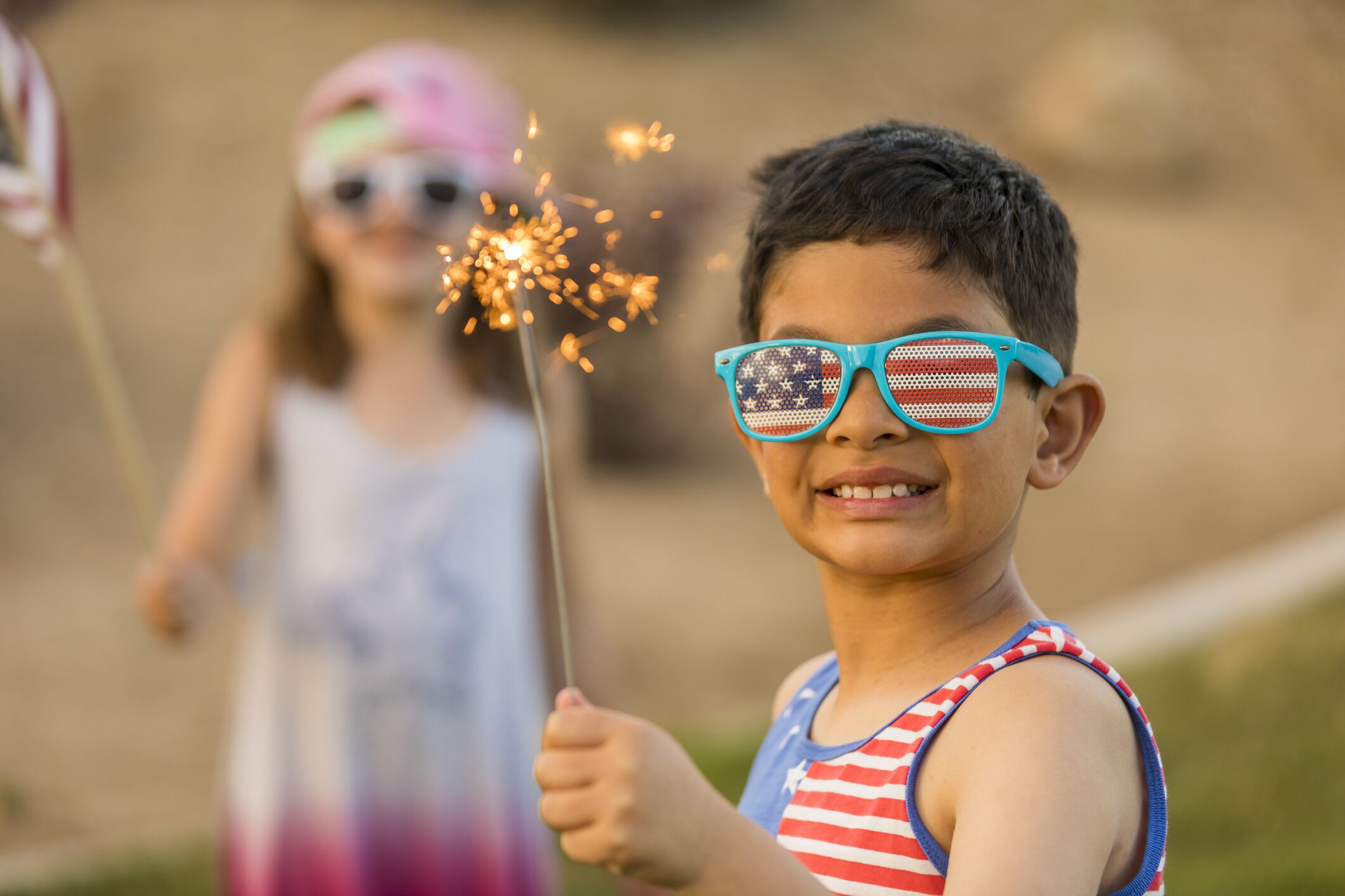 Young boy and girly with sparklers celebrating July 4th Independence Day