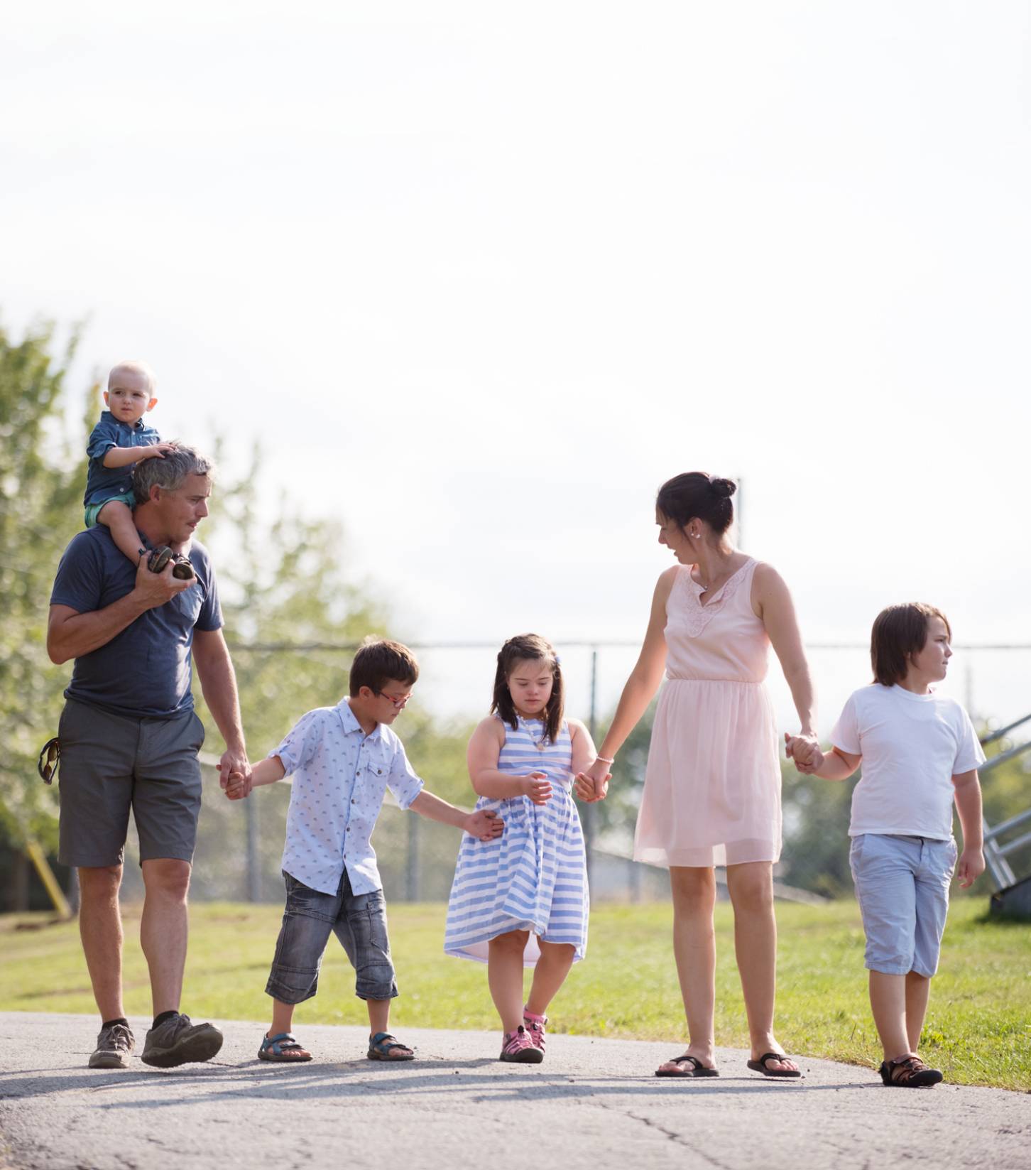 Family of 6 walking in park