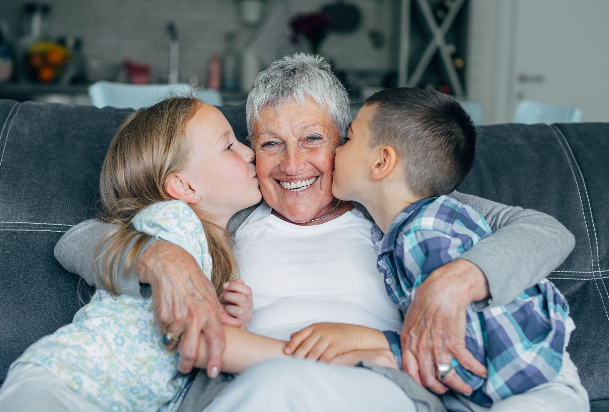 Kids kissing grandma