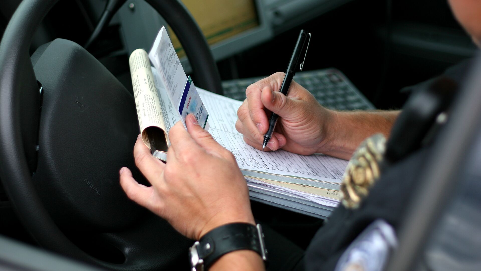 Police officer writing a traffic ticket