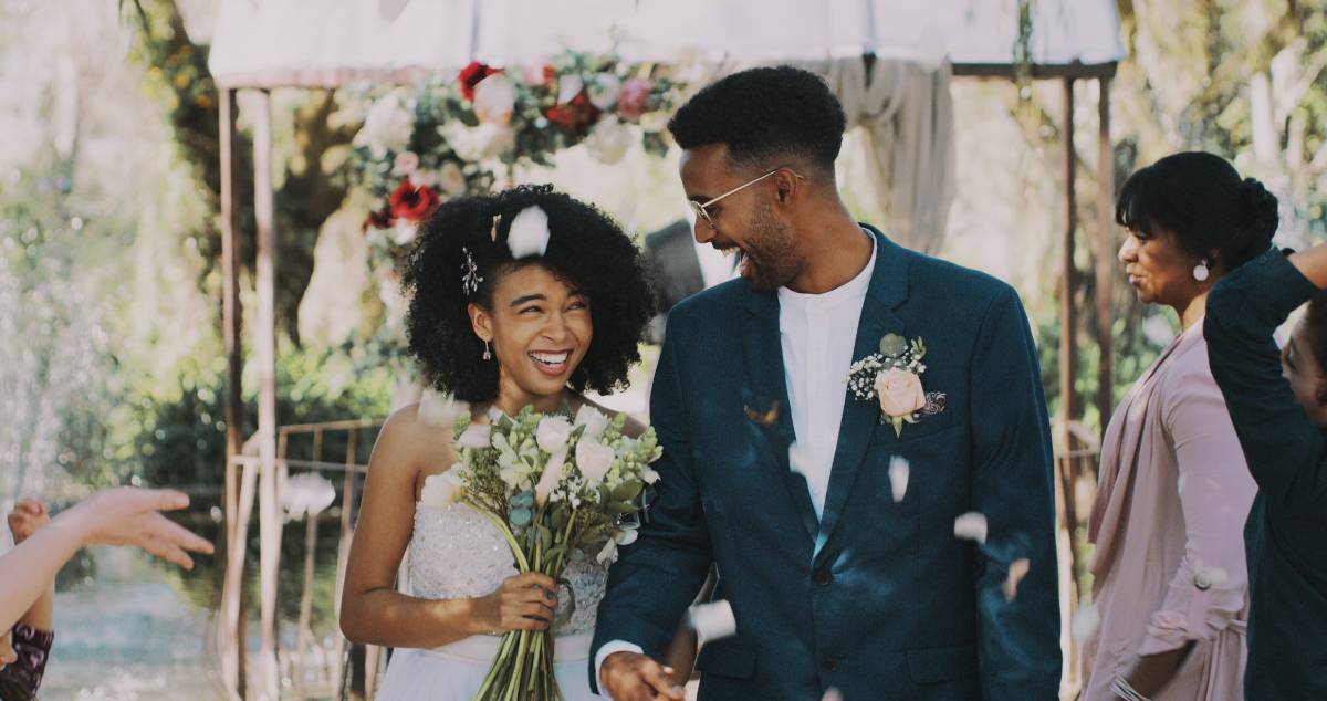 Young couple leaving wedding ceremony