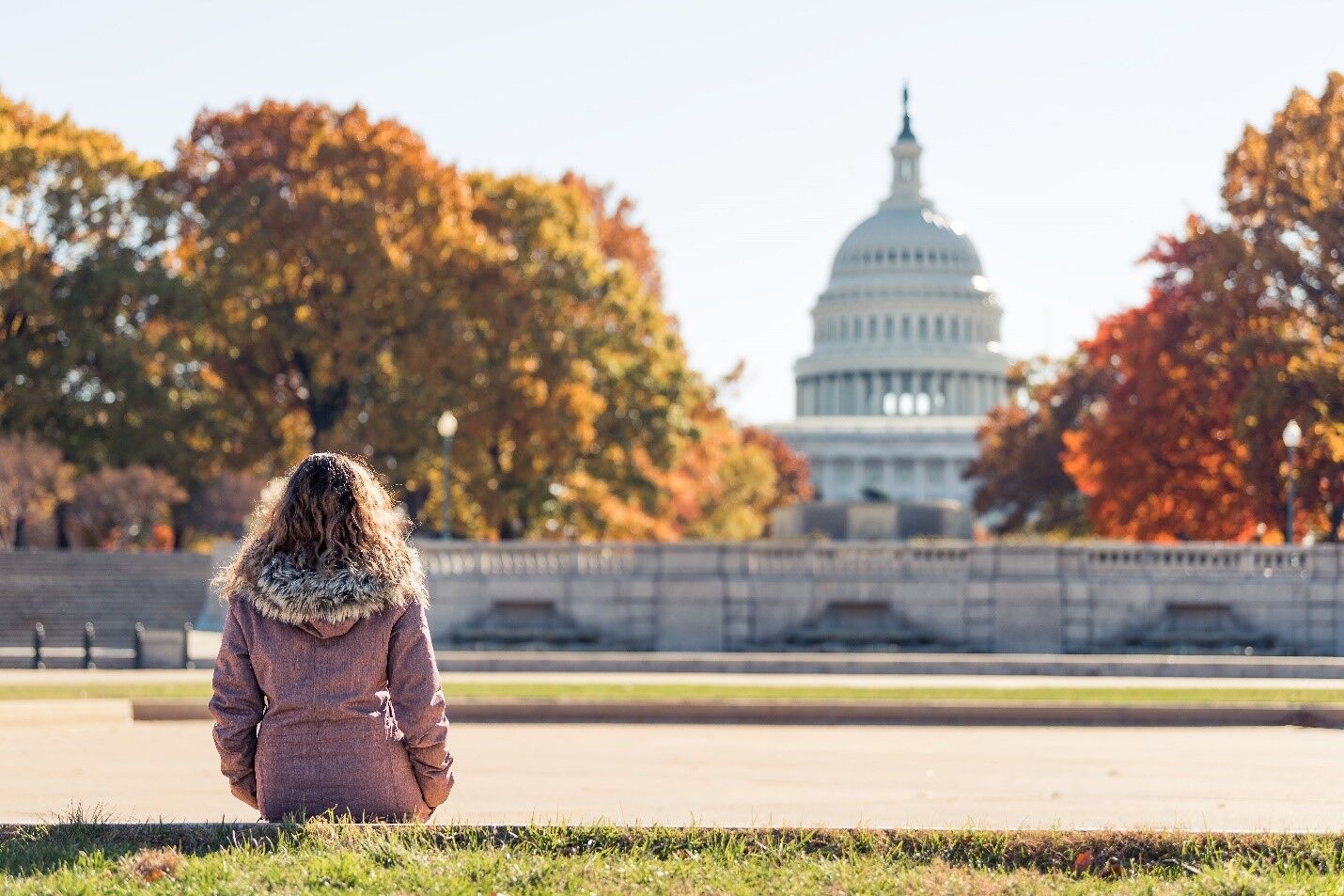 Woman sitting looking at monument