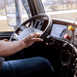 Delivery driver behind the wheel of his vehicle.