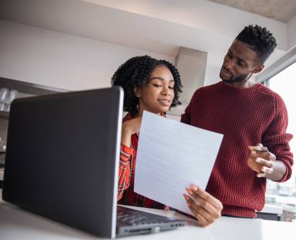 Couple looking at a legal real estate document.