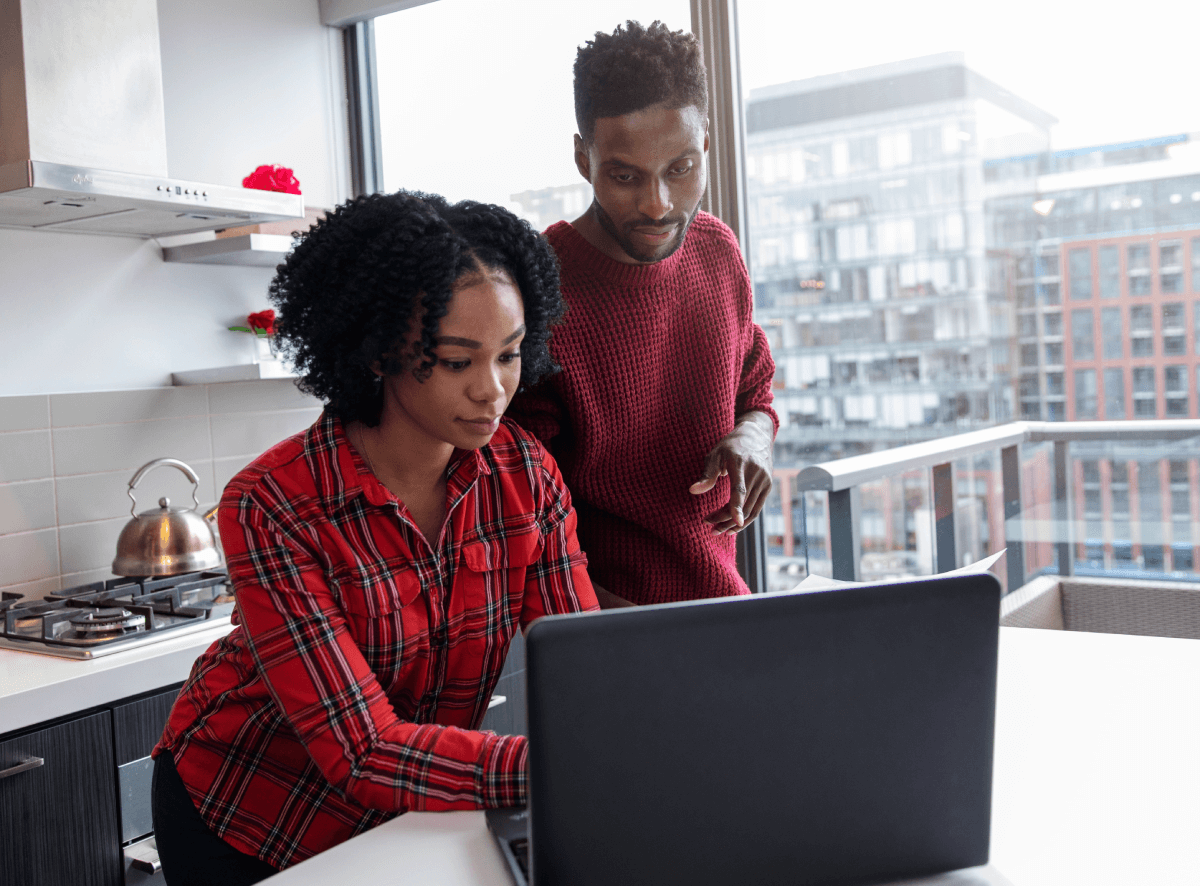 Couple in their kitchen working on their digital real estate business