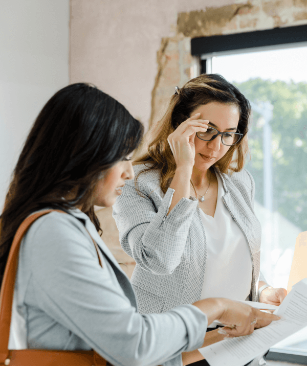 A potential renter pointing out provisions of an office commercial lease to a real estate agent.