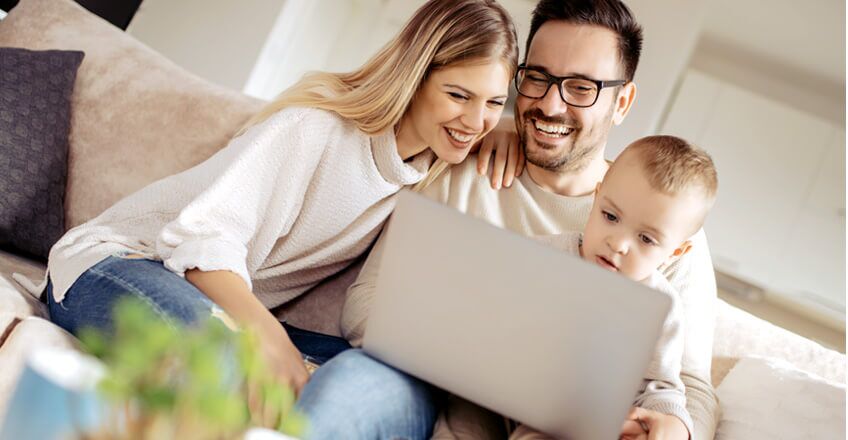 Family looking at laptop together