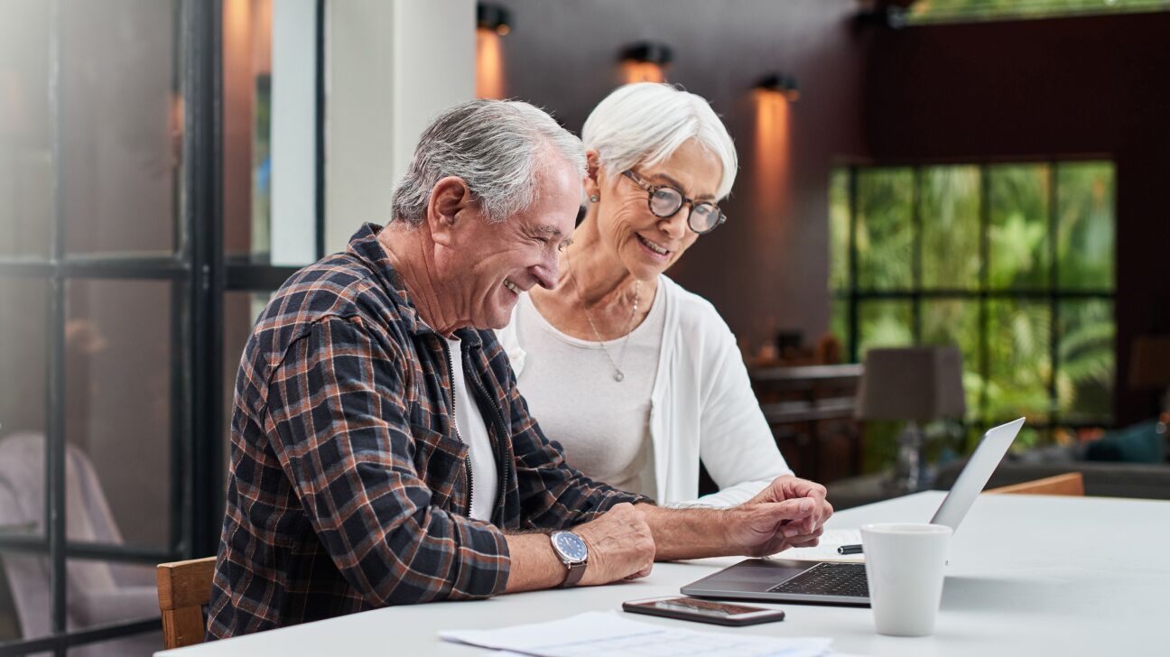 Mature couple doing Estate Planning together using a laptop.