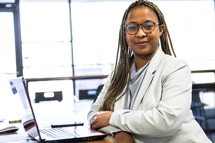 woman sitting at desk with laptop