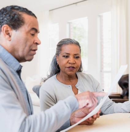 Couple reviewing retirement planning documents.