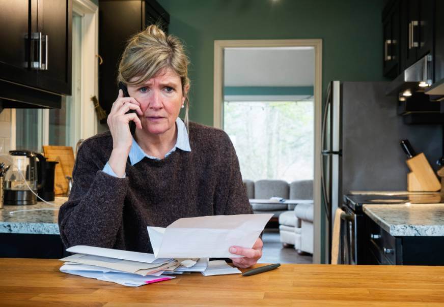 Distraught woman on the phone dealing with a car repossession