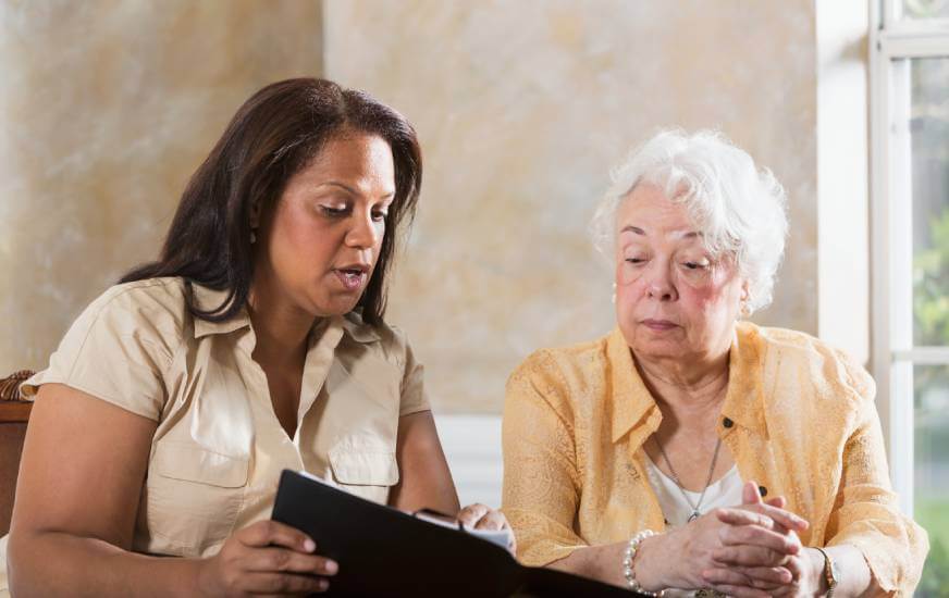 Lawyer explaining to widow estate plan legal advice.