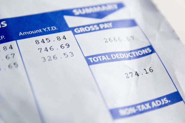 Close-up view of part of a paycheck stub showing Gross Pay and Total Deductions.