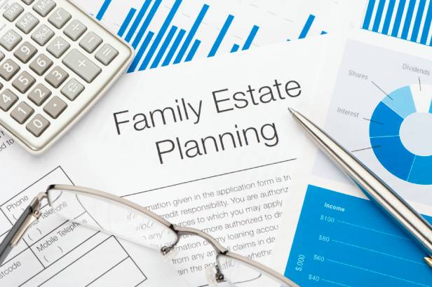 Family Estate Plan documents next to a calculator, ink pen and eye glasses.