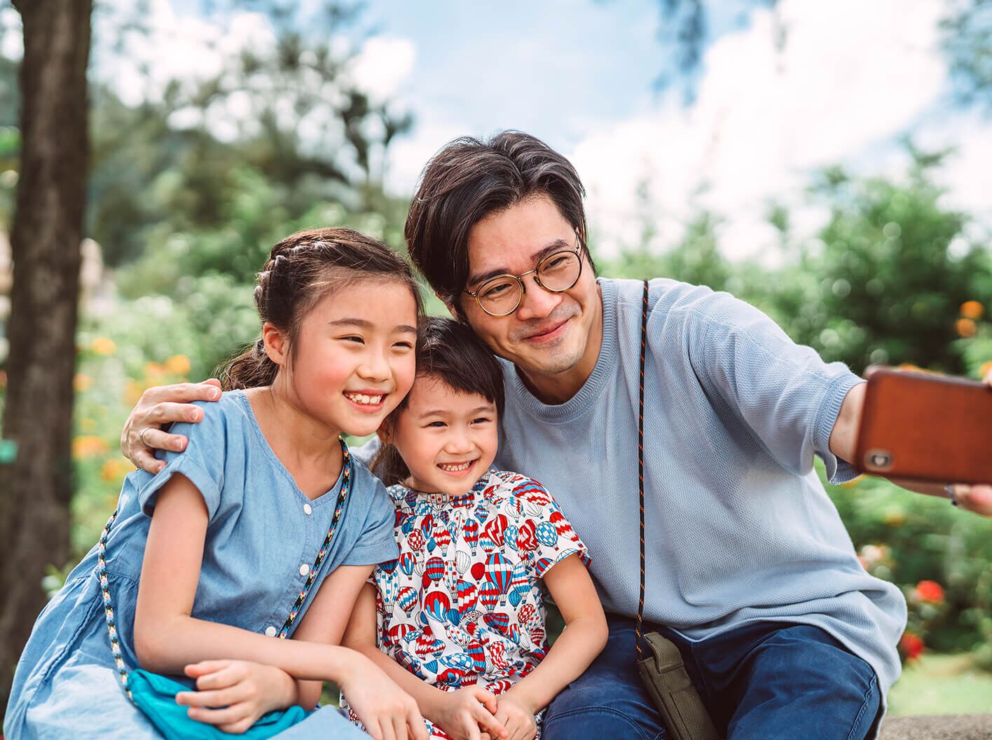 A man taking a selfie of him and his children