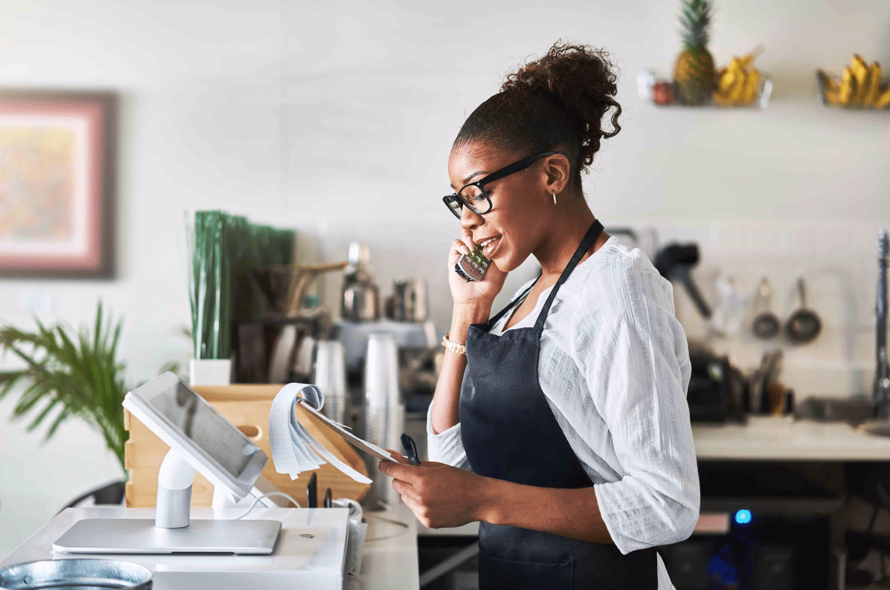 Woman behind the cashier stand making a call