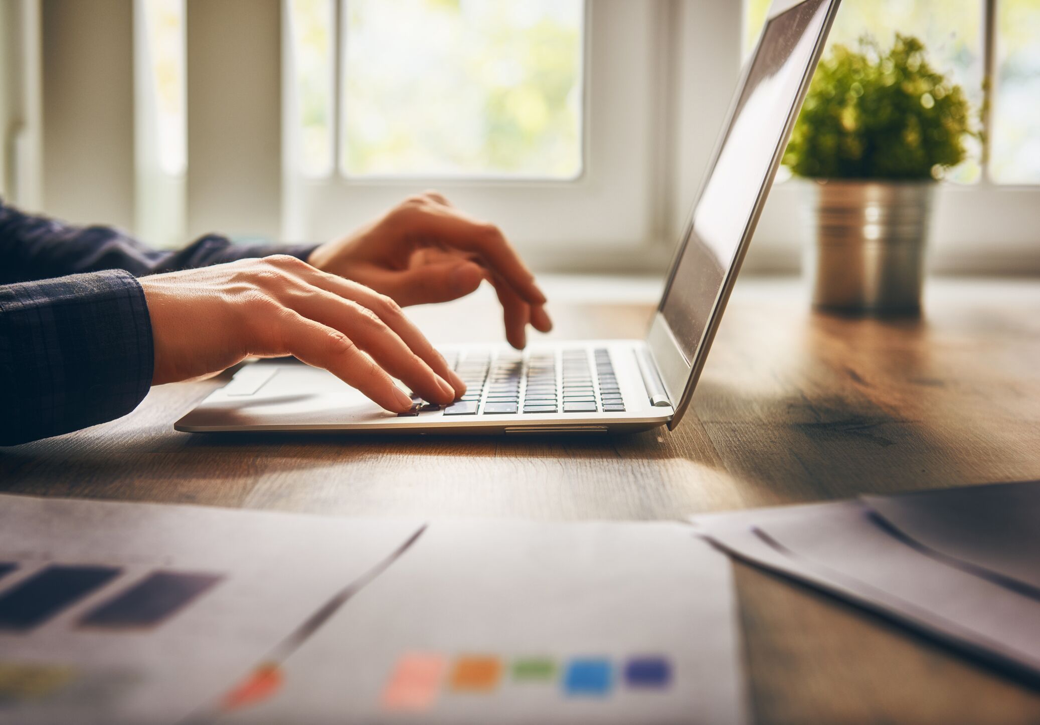 person typing on a laptop at a desk