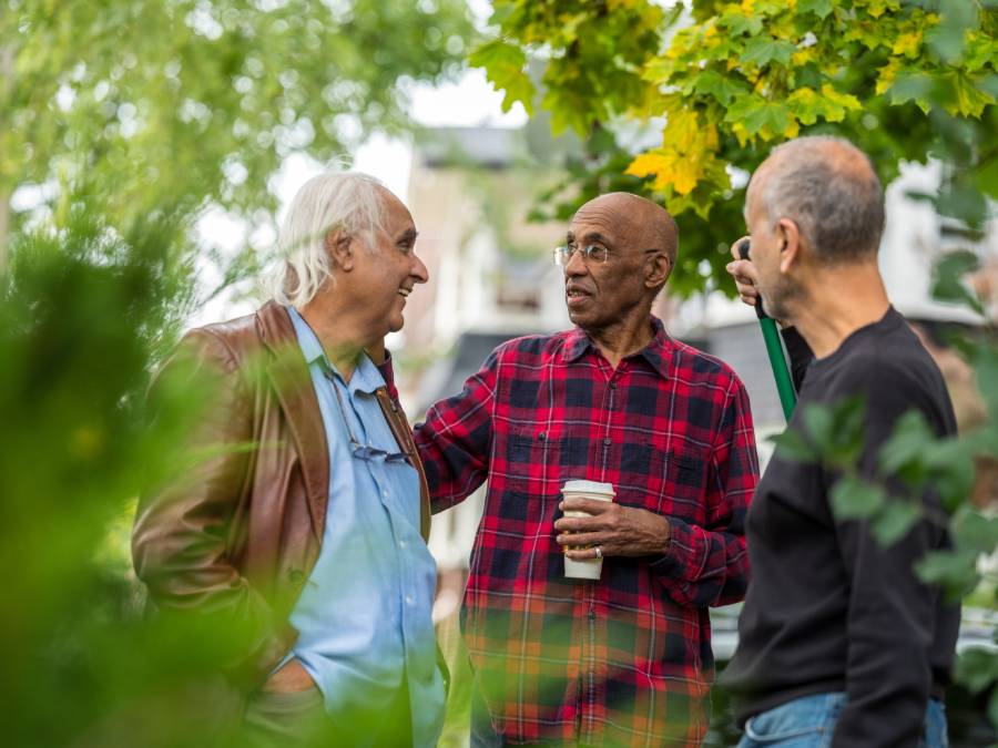 Three male neighbors talking outside about bad neighbors.