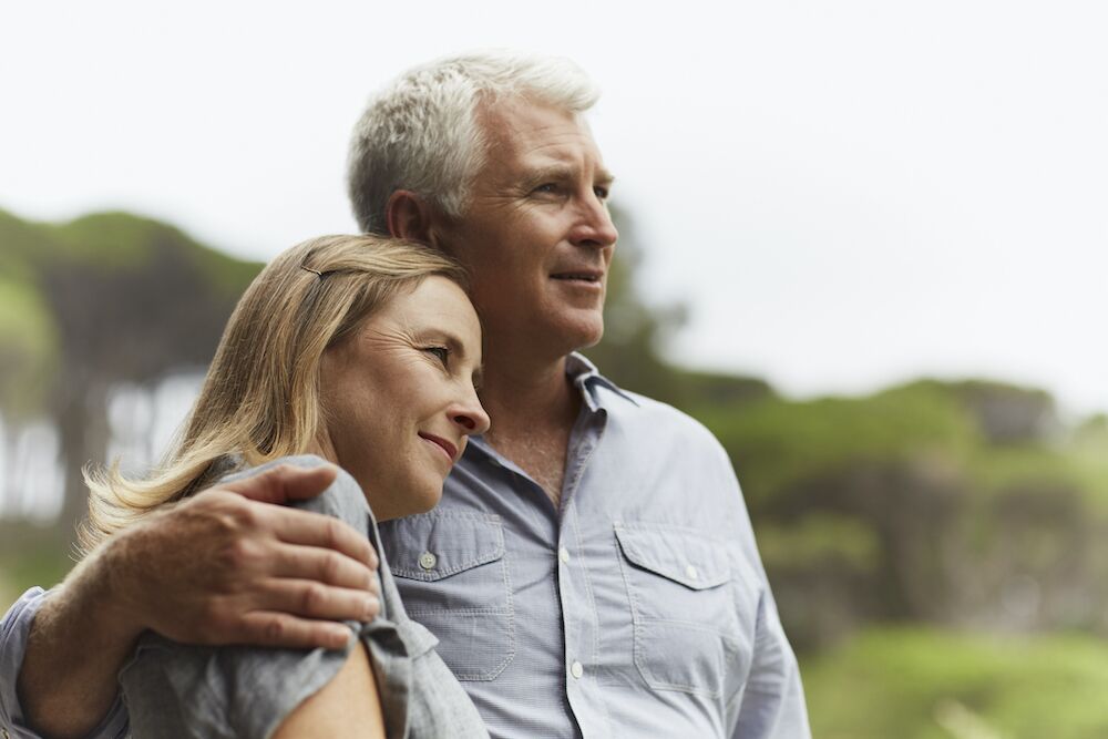 woman resting her head on man's shoulder