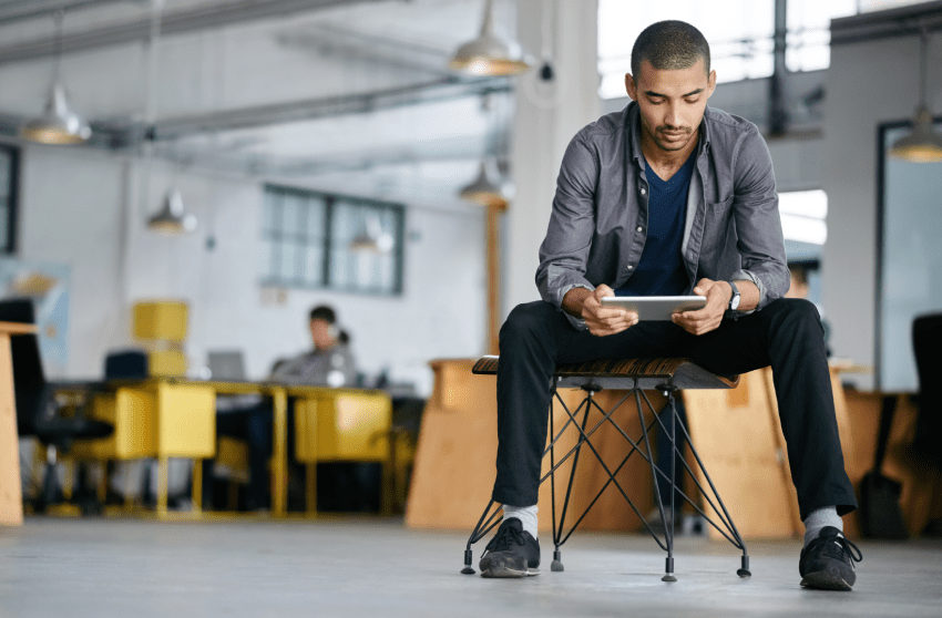 Small business owner looking at his computer tablet.