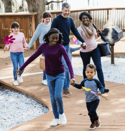 Blended family of 6 running in a park.