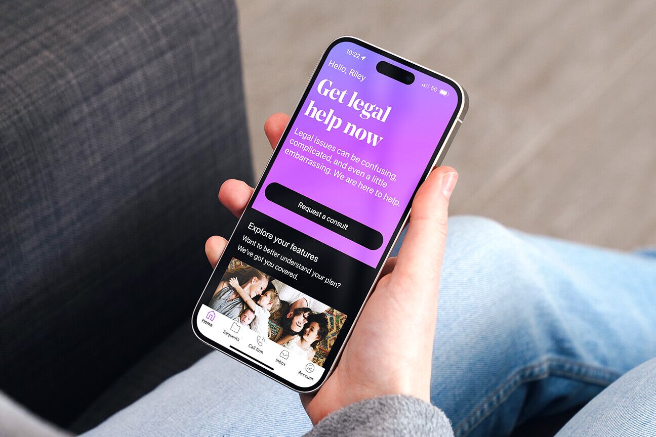 Woman looking at the LegalShield app on her phone.