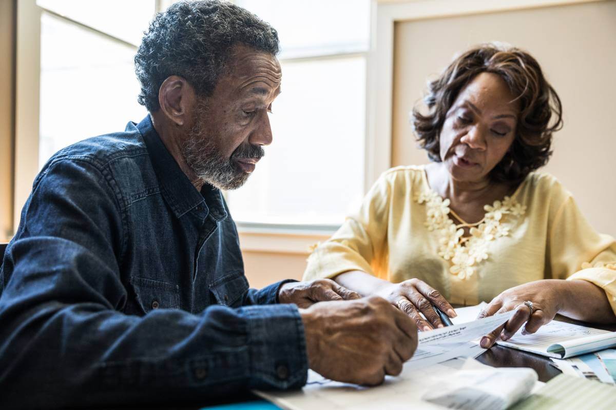 Couple reviewing debt collection documents.