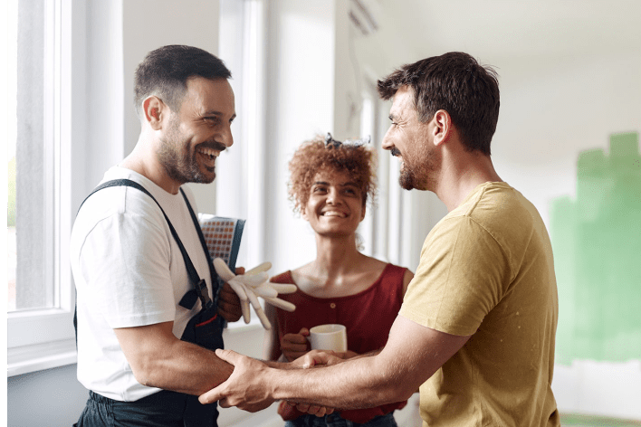 Homeowner and painter shaking hands.