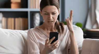 Frustrated woman looking at her smartphone.
