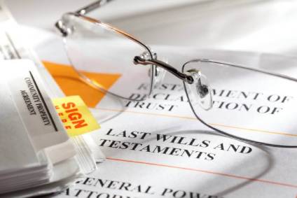 Estate planning documents and a pair of reading glasses.